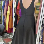 Elegant two-piece set consisting of a cinched-waist peplum jacket and a matching long dress