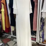 White Maxi Dress featuring a distinctive open-back design with decorative horizontal straps and tiered flutter sleeves.(Free Size)