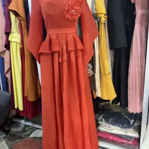 Long Sleeved Maxi Dress with a Peplum Waist and Floral Applique detail on the shoulder.(Free Size)