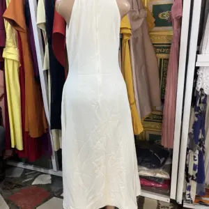 A-line Silhouette and three large yellow floral or button-like embellishments down the center.