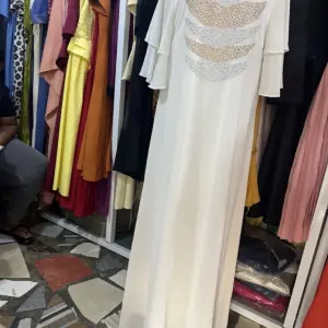 White Maxi Dress featuring a distinctive open-back design with decorative horizontal straps and tiered flutter sleeves.(Free Size)