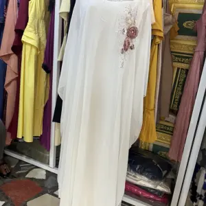 White Butterfly-style Abaya or Kaftan, featuring Floral Embroidery or beaded accents on the upper chest