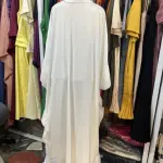 Elegant White Maxi Dress or Abaya with long, flowing sleeves and a full-length Silhouette.