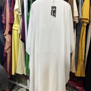 White Kaftan-Style Maxi Dress, Flowing Silhouette with wide, draped Sleeves and a simple round or scoop neckline.