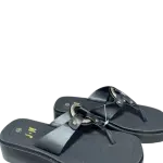 black wedge platform and distinctive gold-tone metal hardware on the T-strap