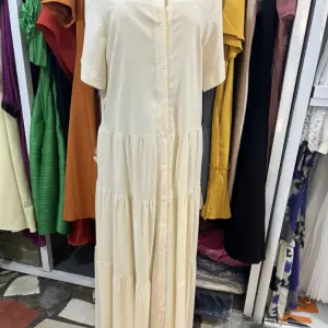 Long-Sleeved, Single-Breasted Pleated Shirt Dress.