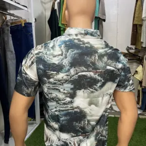 Short-Sleeved Men's Button-down Shirt with a Bold, Abstract Pattern.