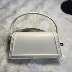 Zara Structured Handbag, with a flap closure and an optional Shoulder Strap.
