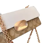 Coach Eliza Flap Crossbody Bag in Signature Canvas, with a light khaki and chalk color combination and a metal chain strap.