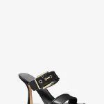 Pointed-toe heeled mules in a smooth black leather double-strap design with a prominent buckle on the upper strap and a stiletto heel.